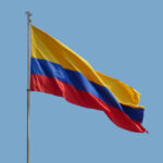 the colombian national flag in front of blue sky